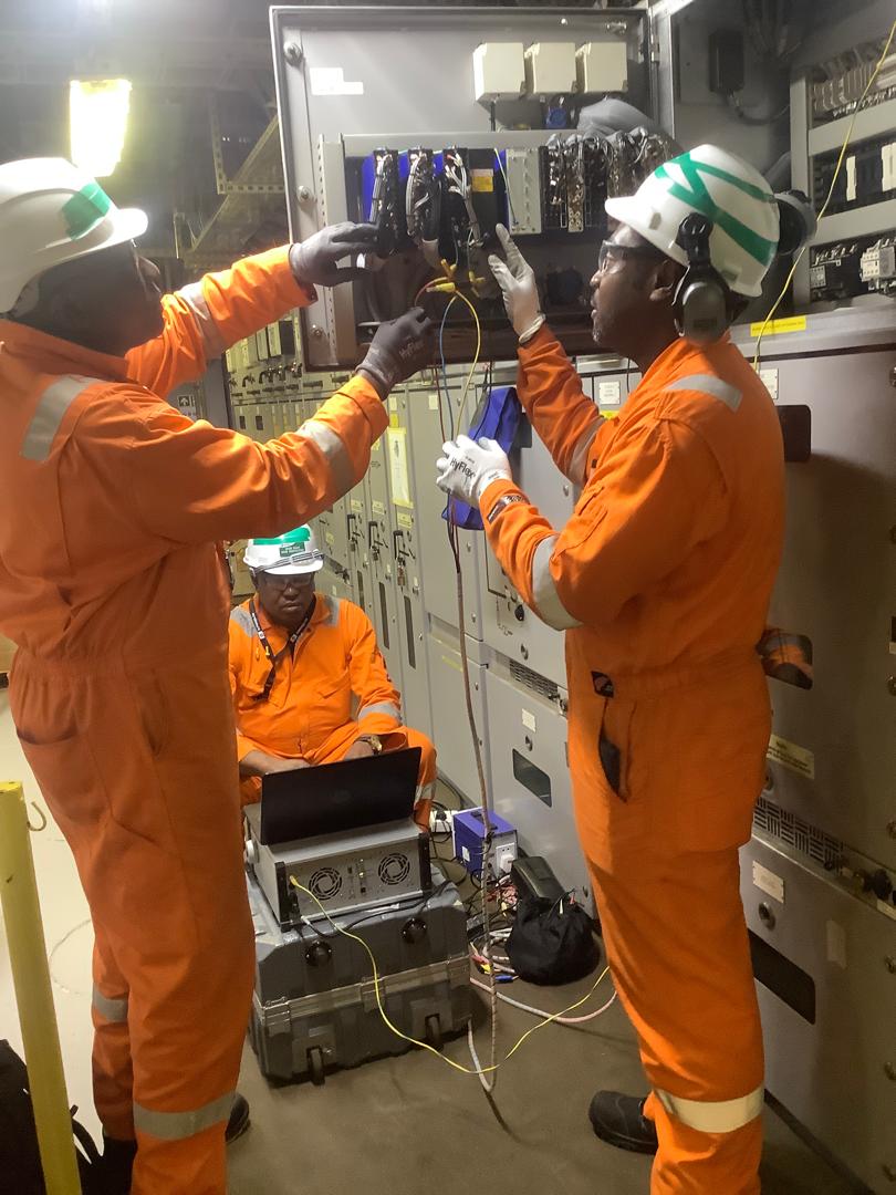 Engineers performing electrical panel work